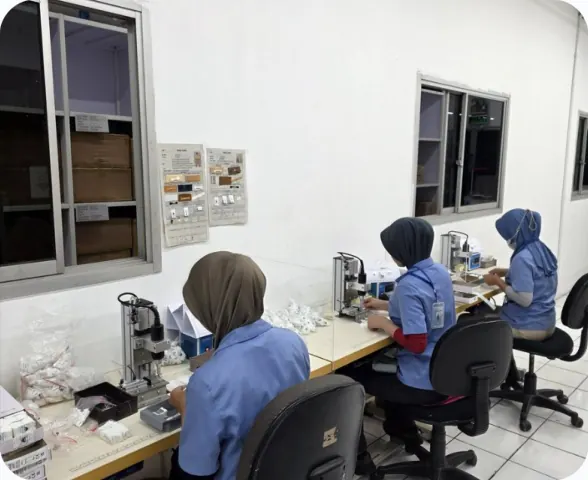 Operators working at label attaching stations